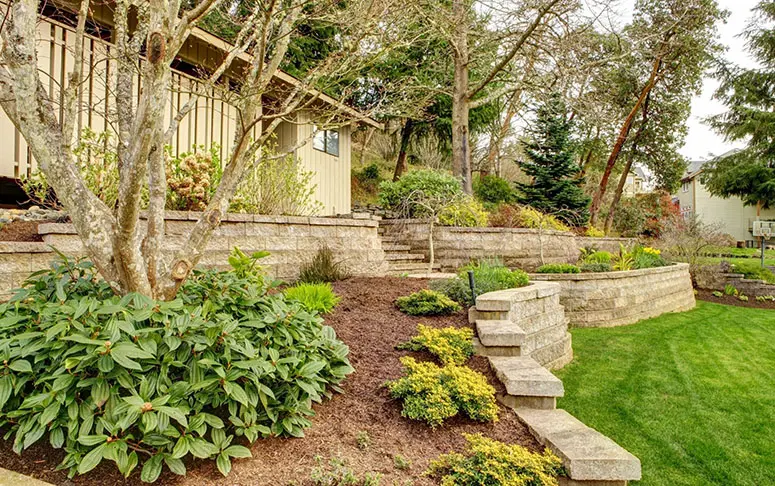 Spring Landscape With Retaining Walls and Garage